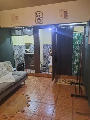 a living room with a couch and a mirror at Beliz Habitación privada con baño privado in Liberia
