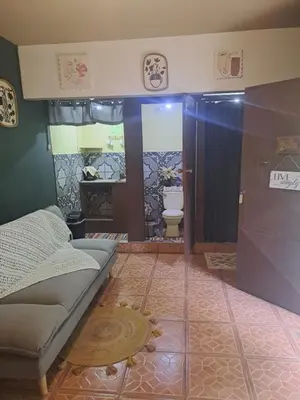 a bathroom with a shower with a couch and a toilet at Beliz Habitación privada con baño privado in Liberia