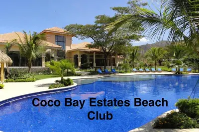 a pool at a resort with the words cocoa bay estates beach club at The Cove Door 15 Main Floor Unit in Ocotal