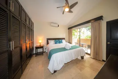 a bedroom with a bed and a ceiling fan at The Cove Door 16 2 Bedroom Upper Unit in Ocotal