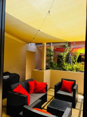 a room with two couches and red pillows at The Cove Door 16 2 Bedroom Upper Unit in Ocotal