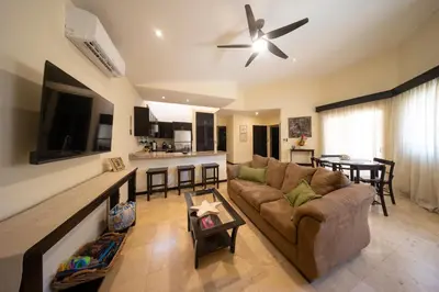 a living room with a couch and a table at The Cove Door 16 2 Bedroom Upper Unit in Ocotal