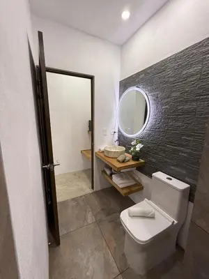 a bathroom with a toilet and a mirror at Creekside Lofts #1 in Fortuna