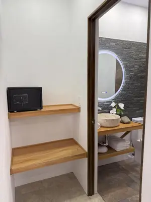 a bathroom with wooden shelves and a mirror at Creekside Lofts #1 in Fortuna