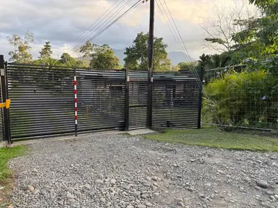 a gate in a field with a fence at Creekside Lofts #1 in Fortuna