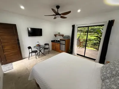a bedroom with a bed and a ceiling fan at Creekside Lofts #1 in Fortuna
