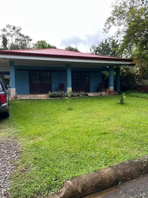 a house with a green lawn in front of it at Nature, Peace & Tranquility in Northern Costa Rica in Santa Rita
