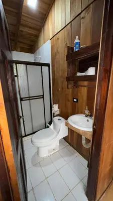 a bathroom with a toilet and a sink at Cabaña Nacahome in Santa Cruz