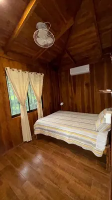 a bedroom with a bed in a room with a window at Cabaña Nacahome in Santa Cruz