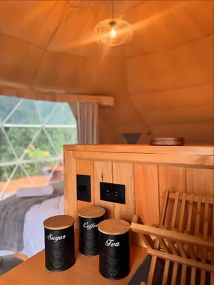 a set of three black trash cans sitting on a table at Epífita, Bosque Nuboso Glamping Monteverde in Monteverde Costa Rica