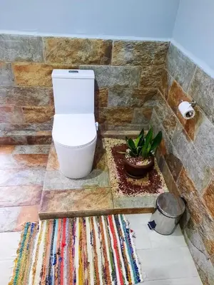 a bathroom with a toilet and a rug at Iki Room with Jacuzzy in Fortuna