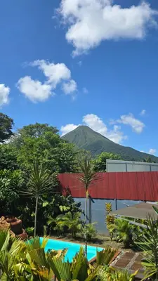 a view of a resort with a mountain in the background at Iki Room with Jacuzzy in Fortuna