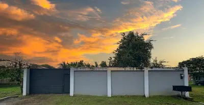 a white garage with a cloudy sky in the background at Costa Amanecer in Uvita