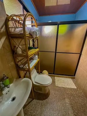 a bathroom with a toilet and a sink at Costa Amanecer in Uvita