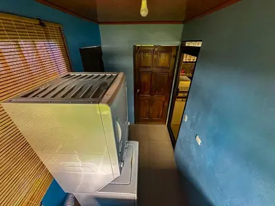 a view of a kitchen with a refrigerator in a room at Costa Amanecer in Uvita