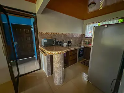 a kitchen with a counter in the middle of it at Costa Amanecer in Uvita