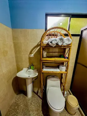 a bathroom with a toilet and a sink at Costa Amanecer in Uvita