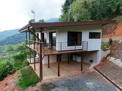 a house on the side of a mountain at VILLA SANTA LUCÍA in front of the waterfall with a mountain view in Ceibo