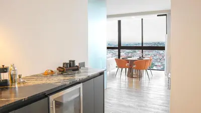 a kitchen and dining room with a view of the city at Zen Urbano View of the Irazu Volcano con Jacuzzi and AC in Curridabat