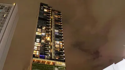 a tall building with lights on at night at Zen Urbano View of the Irazu Volcano con Jacuzzi and AC in Curridabat