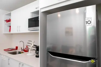 a stainless steel refrigerator in a white kitchen at Lovely space - awesome San Jose view from 26th fl in San José