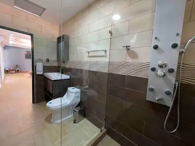 a bathroom with a toilet and a shower at Villa del Sol house with pool & AC in Tapantí