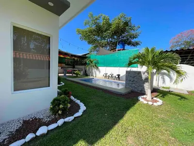 a house with a yard with a swimming pool at Villa del Sol house with pool & AC in Tapantí