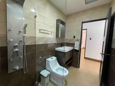 a bathroom with a toilet and a shower at Villa del Sol house with pool & AC in Tapantí