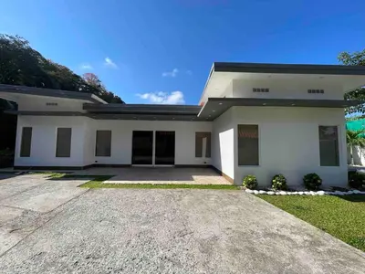 a large white house with a driveway at Villa del Sol house with pool & AC in Tapantí