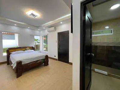 a bedroom with a bed and a glass door at Villa del Sol house with pool & AC in Tapantí