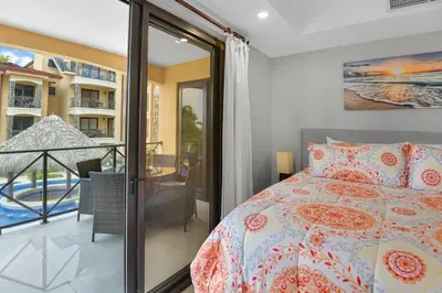 a bedroom with a bed and a balcony at 2 Bedroom Oceanview Beachfront Condo Jaco Beach in Jacó