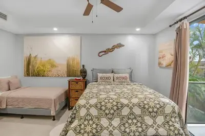 a bedroom with a bed and a window at 2 Bedroom Oceanview Beachfront Condo Jaco Beach in Jacó