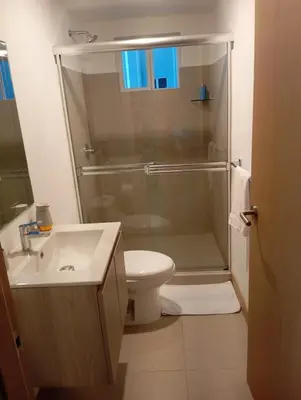 a bathroom with a shower and a toilet and a sink at A short walk from the sea - 2 bedrooms - 2 beds - 2 bathrooms in Jacó