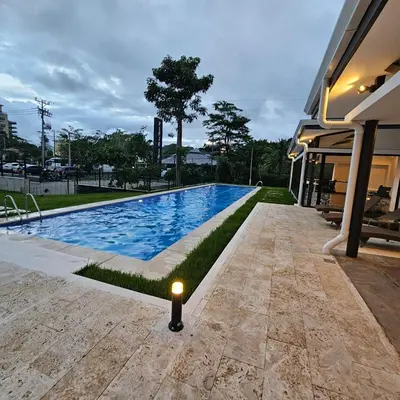 a swimming pool with a light next to a house at A short walk from the sea - 2 bedrooms - 2 beds - 2 bathrooms in Jacó