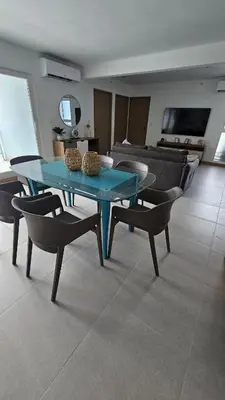 a blue table and chairs in a living room at A short walk from the sea - 2 bedrooms - 2 beds - 2 bathrooms in Jacó
