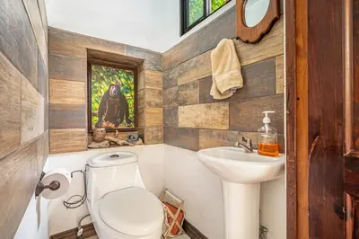 a bathroom with a toilet and a sink at Tiburon Galano - Playa Carrillo in Carrillo