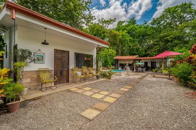a patio of a house with chairs and a pool at Tiburon Galano - Playa Carrillo in Carrillo