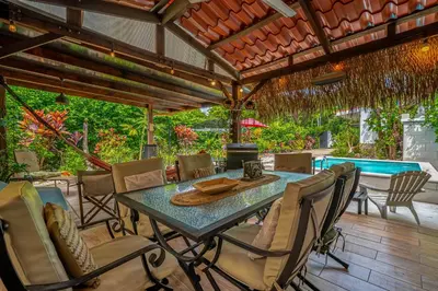 a patio with a table and chairs and a pool at Tiburon Galano - Playa Carrillo in Carrillo