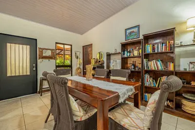 a dining room with a wooden table and chairs at Tiburon Galano - Playa Carrillo in Carrillo