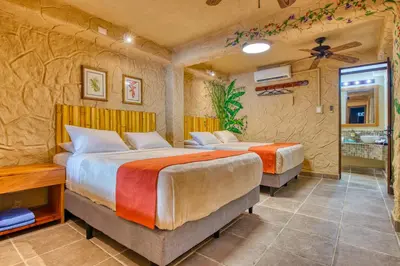 a bedroom with two beds in a room at Ylang Ylang Beach Resort in Montezuma