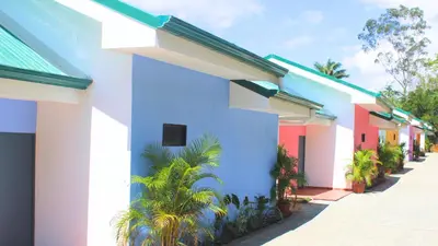 a row of houses with colorful paint at Hotel El Arca, Jardín Botánico y Restaurante in Santa Bárbaraa