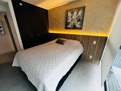 a bedroom with a bed with a picture on the wall at Luxurious 9th floor apartment in Vuelta del Virilla