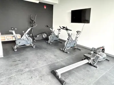 a gym with several exercise bikes and a flat screen tv at Luxurious 9th floor apartment in Vuelta del Virilla