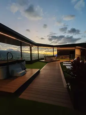 a rooftop deck of a building with a sunset at Fantastic 1607 Ser ESCALANTE in San José