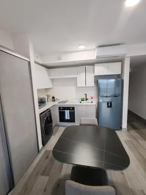 a kitchen with a black table and a refrigerator at Fantastic 1607 Ser ESCALANTE in San José