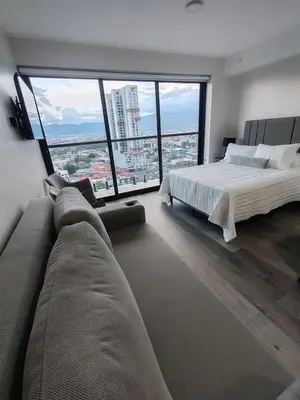 a large bedroom with a bed and a large window at Fantastic 1607 Ser ESCALANTE in San José