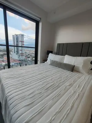 a large white bed in a bedroom with a large window at Fantastic 1607 Ser ESCALANTE in San José