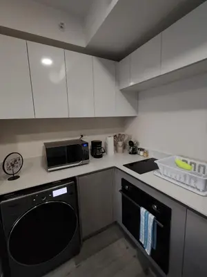 a kitchen with white cabinets and a black oven at Fantastic 1607 Ser ESCALANTE in San José