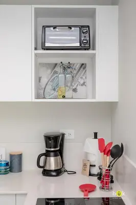 a kitchen with a counter top with a toaster oven at Sunset view URBN Studio 16th floor in San José