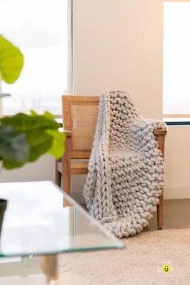 a rattan chair sitting next to a glass table at INSTAWORTHY CORNER VIEW 200Mbps in San José